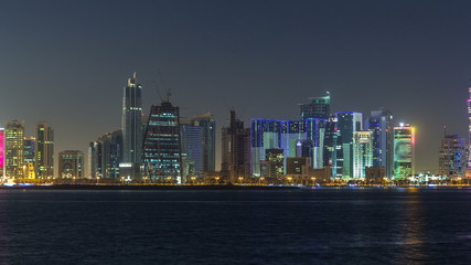 Obraz premium Doha skyscrapers in downtown skyline night timelapse, Qatar, Middle East