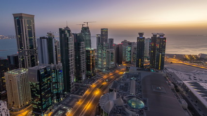 The skyline of the West Bay area from top in Doha night to day timelapse, Qatar.