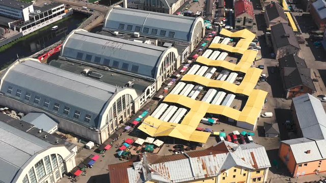 RIGA, LATVIA - MAY, 2019: Aerial drone view of the central market with many pavilions near historical centre of Riga.