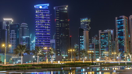Obraz na płótnie Canvas The skyline of Doha by night with starry sky seen from Park timelapse, Qatar