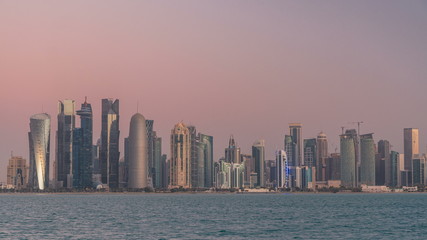 Fototapeta na wymiar Skyline of Doha night to day transition timelapse in Qatar