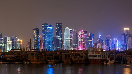 A panoramic view of the old dhow harbour night timelapse in Doha, Qatar, with the West Bay skyline in the background.