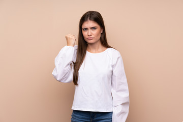 Young girl over isolated background with angry gesture