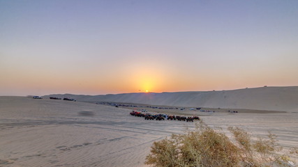 Buggies in sand desert at the sunset timelapse