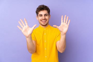 Caucasian man isolated on purple background counting ten with fingers