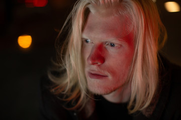 Portrait of a man with white hair looks away