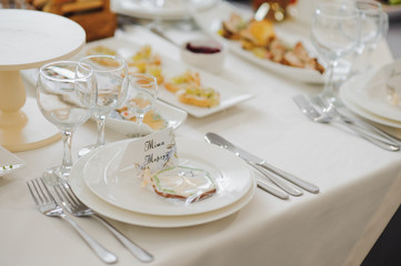 Glasses on the festive table setting. Wedding table decor concept. Table setting in classic style, setout. fine art.