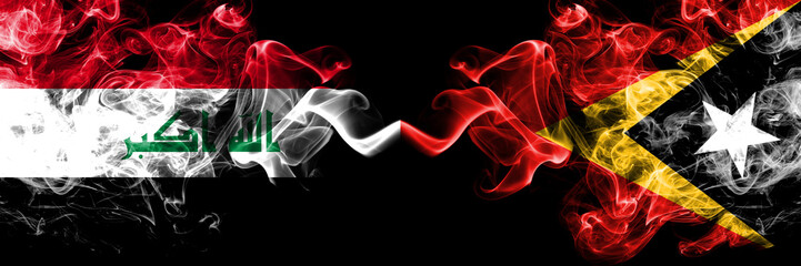Iraq, Iraqi vs East Timor smoky mystic flags placed side by side. Thick colored silky smokes flags together.