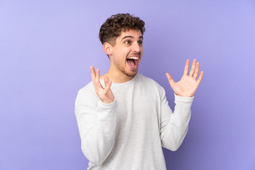 Caucasian man isolated on purple background with surprise facial expression