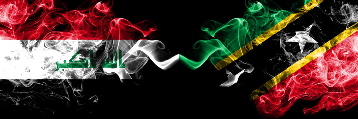 Iraq, Iraqi vs Saint Kitts and Nevis smoky mystic flags placed side by side. Thick colored silky smokes flags together.