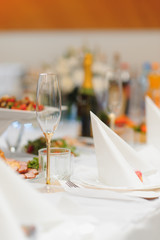 Glasses on the festive table setting. Wedding table decor concept. Table setting in classic style, setout. fine art.