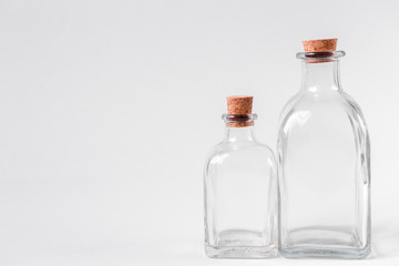 Glass bottles with cork on a white background