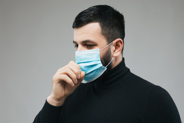  Closeup of  guy wearing a protection mask.  Copy space for your text. Novel coronavirus 2019 concept.