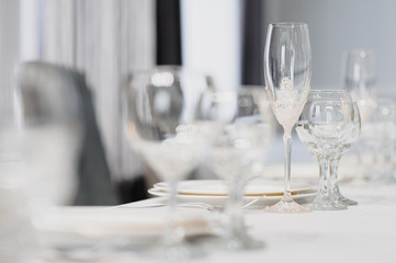 Glasses on the festive table setting. Wedding table decor concept. Table setting in classic style, setout. fine art.