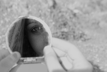She looks at herself in the mirror.