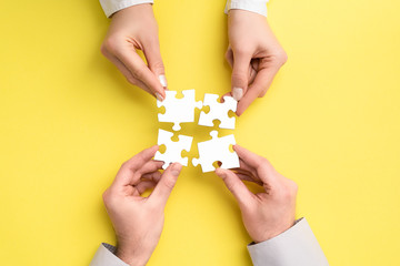 People holds in hand a jigsaw puzzle. Business solutions, success and strategy.
