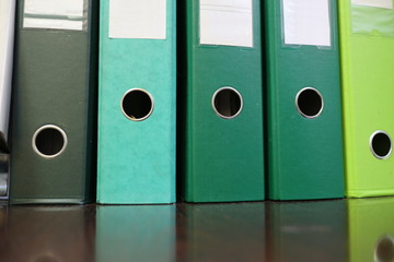 green office folders on the table