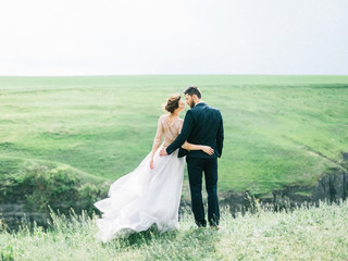 Sensual portrait of a young couple. Wedding photo outdoor. Amazing wedding couple. Beautiful bride...