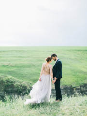 Sensual portrait of a young couple. Wedding photo outdoor. Amazing wedding couple. Beautiful bride...