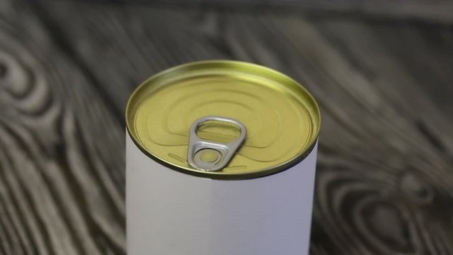 Men's socks in a gift tin can. A man opens a can, takes socks out of it. Close-up shot.