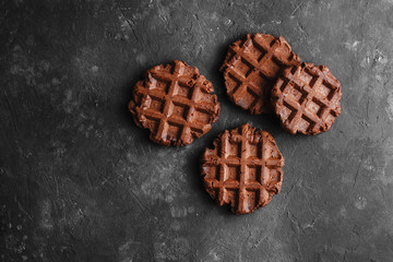 Homemade chocolate waffles with cocoa on a dark background space for text