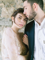 Elegant portrait of couple on ceremony. Wedding photo outdoor. Amazing wedding couple. Beautiful bride and stylish groom.