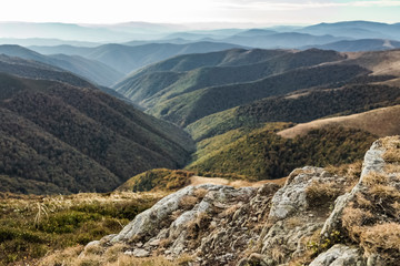 Mountain landscape. change of seasons of autumn. In the background there are bright autumn trees.