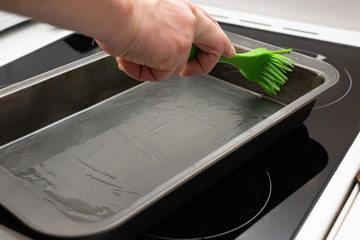 greasing baking sheet with oil
