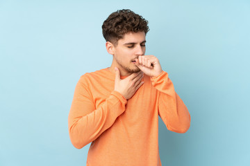 Caucasian man isolated on blue background is suffering with cough and feeling bad