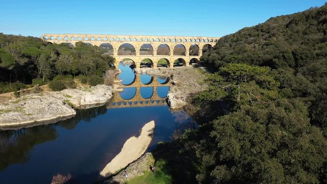 old bridge over the river Gardon Pont du gard perfect reflection aerial shot France