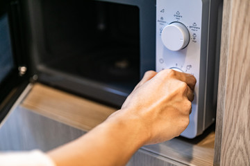 Naklejka premium Using microwave oven, close up