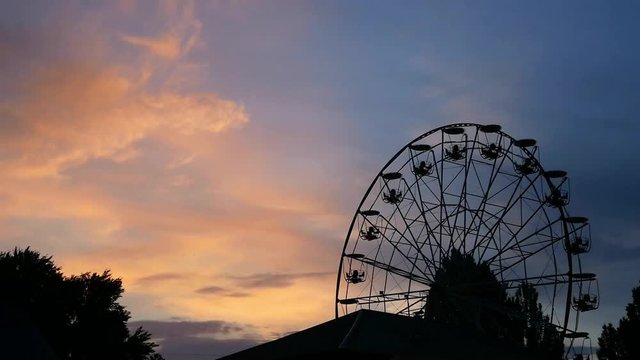 Ferris wheel on night damatic sky, don't move. Beautiful sunst time.