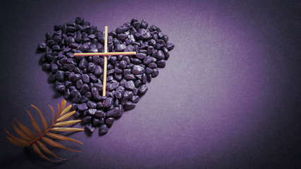 Lent Season,Holy Week and Good Friday concepts - photo of wooden cross with stones and palm leave in purple vintage background
