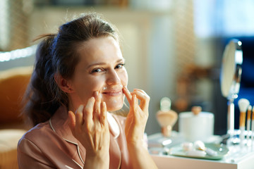 happy modern woman applying lip contour cream