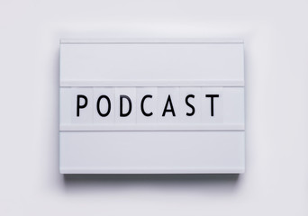 lightbox board on a white background with the words podcast in black letters.