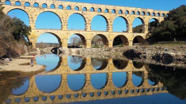 Pont du Gard reflection on the river le Gardon France aqueduct bridge aerial shot sunny day 