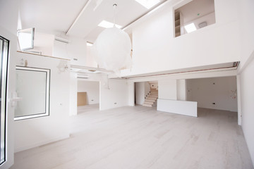 Interior of empty stylish modern open space two level apartment