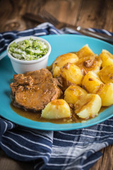 Braised meat in sauce served with boiled potatoes.