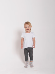  Baby girl in a white shirt on a white background