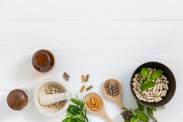 Herbal supplement in capsules with healthy medicinal plant.Alternative drug or natural...