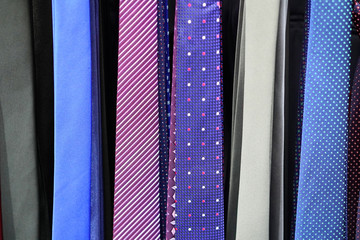 Men's ties hanging on a display case