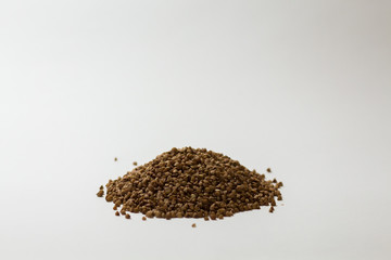 heap of buckwheat on a white background