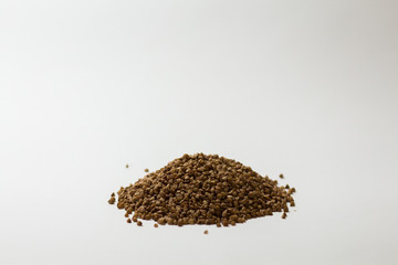 heap of buckwheat on a white background