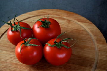 Ripe tomatoes on a cutting Board