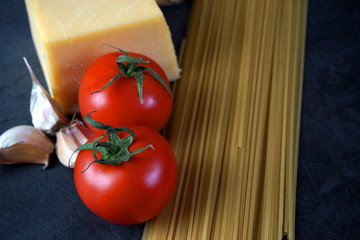 Spaghetti pasta with cheese tomatoes and garlic. Selective focus