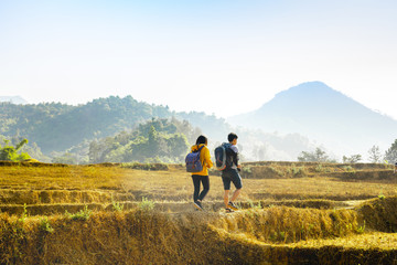 Fototapeta na wymiar adventure travel from asian couple hiking and walk to the mountain in summer season