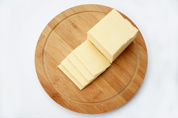 Cheese on a cutting Board isolated on a light background