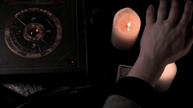 the person passes his hand over the burning candles, then turns the CJ card over with death.  mystical video