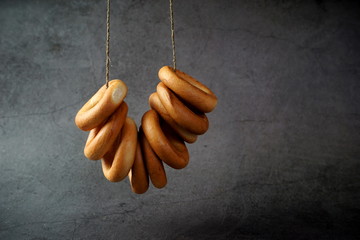 A bunch of baked bagels on a rope
