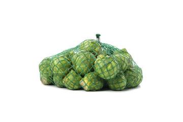 Obraz premium Mesh bag with brussels sprout isolated on white background